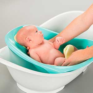 baby being washed in convertible baby bathtub